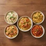 Five easy one-pot meals including shrimp linguine, chicken orzo, Boursin penne, chicken piccata, and tomato beef pasta arranged in a top-down view
