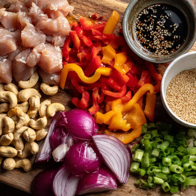 Easy Sheet Pan Cashew Chicken Delight – A Flavor-Packed One-Pan Dinner 5 Fresh stir-fry ingredients including diced chicken, bell peppers, red onions, green onions, cashews, and sesame sauce