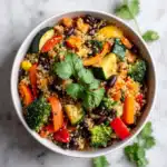one-pot quinoa and veggie bowl with carrots, broccoli, bell peppers, zucchini, and black beans