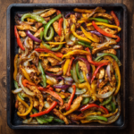 Sheet pan chicken fajitas with peppers and onions on a tray