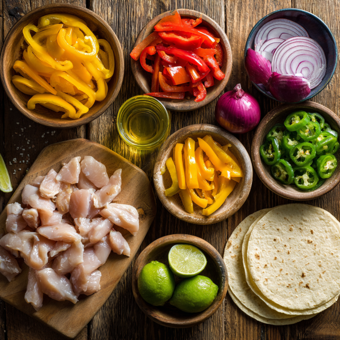 Ingredients laid out for making sheet pan chicken fajitas
